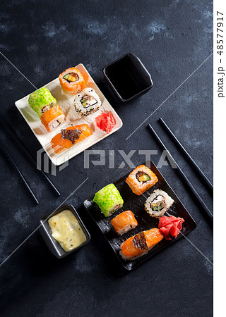 Traditional Japanese food- sushi, rolls, chopsticks, soy sauce on black slate background. Sushi menu 48577917