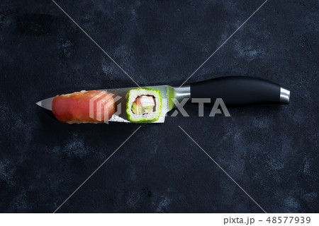 Different Sushi served on japanese knife on a black slate plate . flat lay. Different Sushi served on japanese knife on a black slate plate . flat lay. 48577939