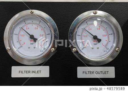 Two pressure gauges on a black background close-up Two pressure gauges on a black background close-up 48579589