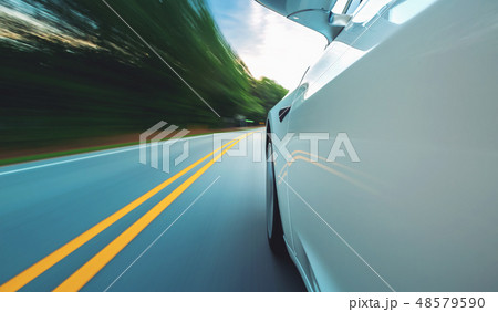 Motion blurred image a luxury vehicle driving Motion blurred image a luxury vehicle driving 48579590