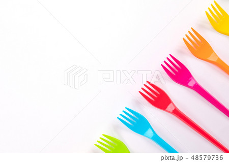 Many color plastic forks on a bright background 48579736