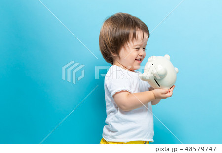 Toddler boy with a piggy bank 48579747