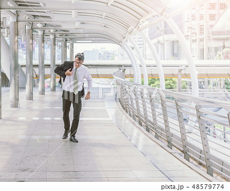 businessman in a hurry and running, he is late businessman in a hurry and running, he is late 48579774