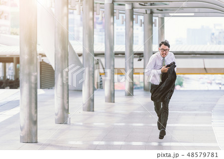 businessman in a hurry and running, he is late 48579781