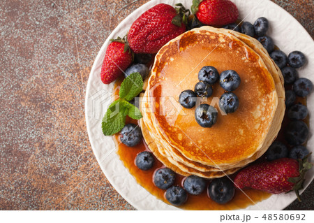 A stack of homemade pancakes with fresh berries. A stack of homemade pancakes with fresh berries. 48580692