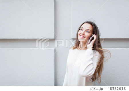 Beautiful young girl talk to a friend on the phone Beautiful young girl talk to a friend on the phone 48582018