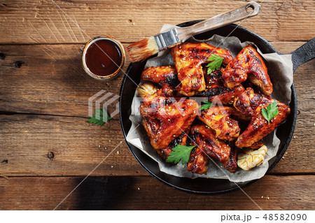 Baked chicken wings in barbecue sauce. Baked chicken wings in barbecue sauce. 48582090