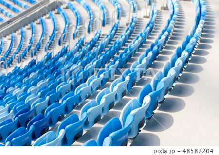 Rows of blue seats at football stadium. Rows of blue seats at football stadium. 48582204