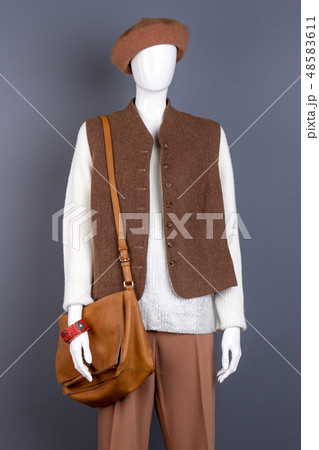 Female mannequin in brown stylish apparel. Female mannequin in brown stylish apparel. 48583611