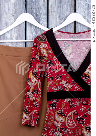 Female apparel hanging on hanger. 48583728