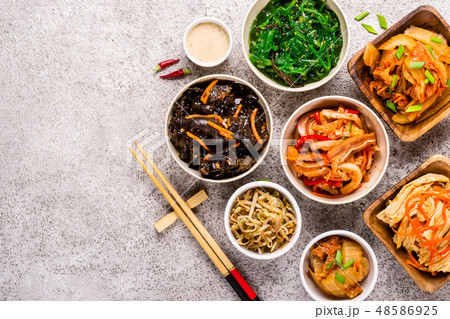 Assorted korean pickled food and chopsticks on gr Assorted korean pickled food and chopsticks on gr 48586925