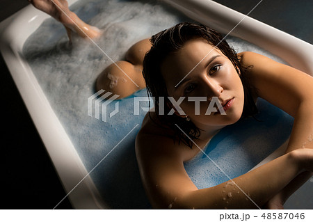 Nude brunette in bath high angle shot Nude brunette in bath high angle shot 48587046