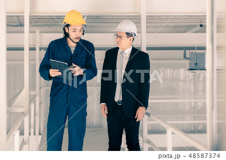 Young engineer present work to executive engineer. Young engineer present work to executive engineer. 48587374