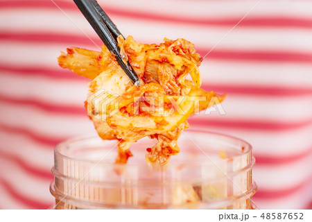 Kimchi cabbage in a bowl with chopsticks Kimchi cabbage in a bowl with chopsticks 48587652