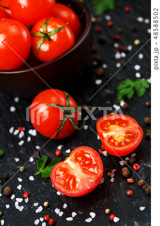 Fresh Tomatoes on a black background with spices Fresh Tomatoes on a black background with spices 48588502