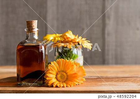A bottle of calendula tincture with calendula A bottle of calendula tincture with calendula 48592204