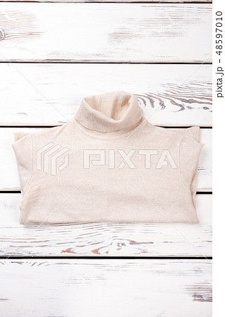 Female warm sweater, wooden background. Female warm sweater, wooden background. 48597010