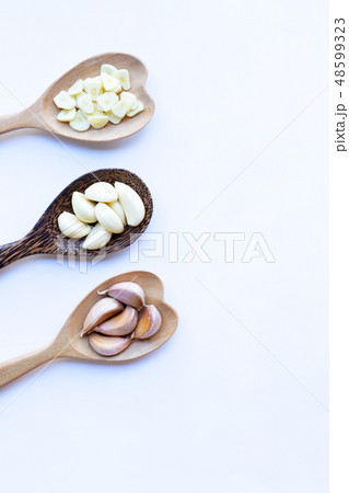 Garlic on wooden spoon on white 48599323