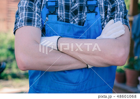 Happy young gardener with crossed hands Happy young gardener with crossed hands 48601068