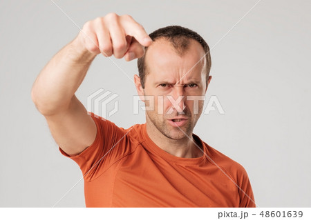 Mature man in orange t-shirtfinger pointing   48601639
