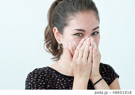 Playful shy woman hiding face with her hands Playful shy woman hiding face with her hands 48601918
