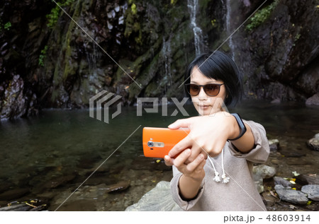 woman selfie near the waterfall woman selfie near the waterfall 48603914