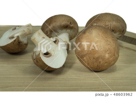 Fresh whole and halved brown Baby Bella mushrooms Fresh whole and halved brown Baby Bella mushrooms 48603962