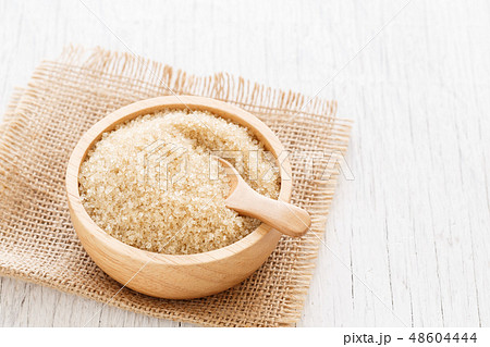 brown sugar and wood spoon in brown bowl brown sugar and wood spoon in brown bowl 48604444