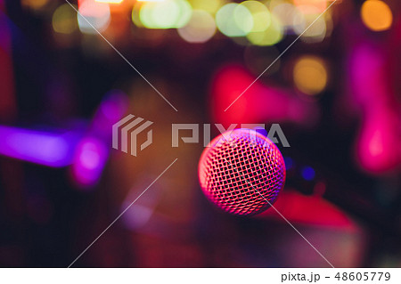 microphone against blur on beverage in pub and restaurant background. microphone against blur on beverage in pub and restaurant background. 48605779
