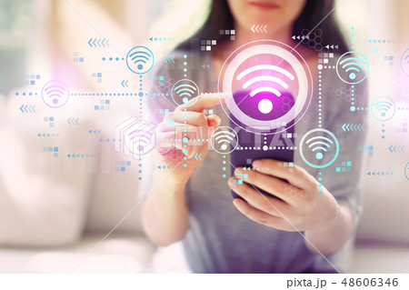 Wifi concept with woman using a smartphone Wifi concept with woman using a smartphone 48606346