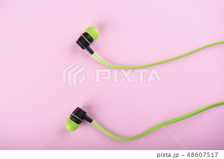 Green headphones or earphones isolated 48607517