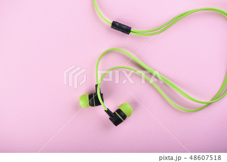 Green headphones or earphones isolated 48607518
