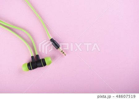 Green headphones or earphones isolated 48607519