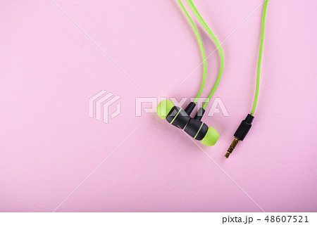 Green headphones or earphones isolated Green headphones or earphones isolated 48607521