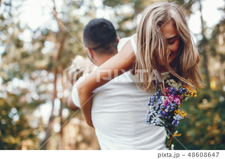 Beautiful couple spend time in a summer park Beautiful couple spend time in a summer park 48608647