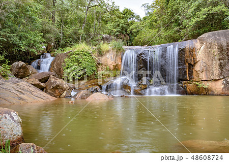 Cascade and lake in the rain forest between stones Cascade and lake in the rain forest between stones 48608724