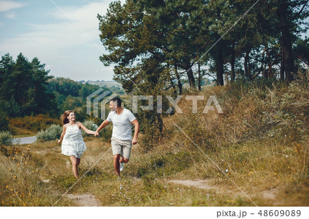 Beautiful couple spend time in a summer park 48609089