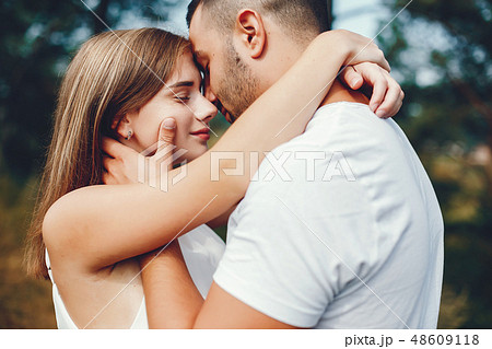 Beautiful couple spend time in a summer park Beautiful couple spend time in a summer park 48609118