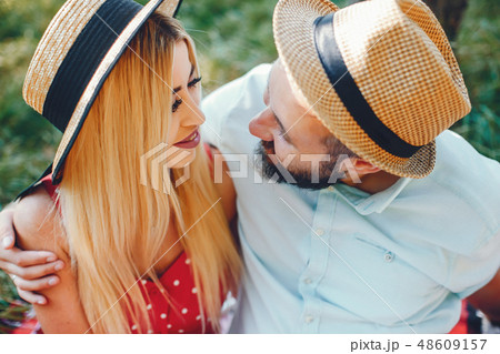 Beautiful couple spend time in a summer park Beautiful couple spend time in a summer park 48609157