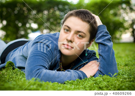 Beautiful girl with short hair on the grass. 48609266