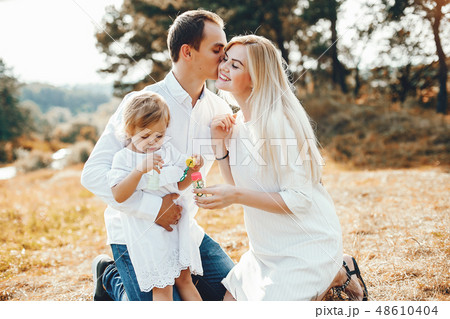 Cute family playing in a summer park Cute family playing in a summer park 48610404