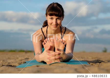 Portrait of sporty young woman practicing yoga Portrait of sporty young woman practicing yoga 48610633
