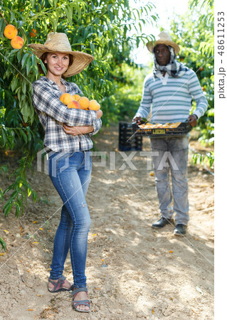 Female with peaches in hands 48611253