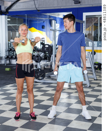 Couple during weightlifting workout Couple during weightlifting workout 48611389