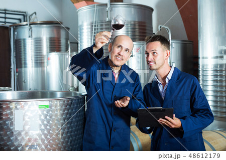 Workers taking notes wine sample 48612179