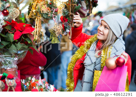 Girl shopping Christmas decorations 48612291