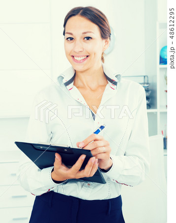 smiling woman with clip in office smiling woman with clip in office 48612295