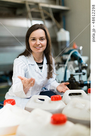 Portrait of female posing with olive oil containers Portrait of female posing with olive oil containers 48612298