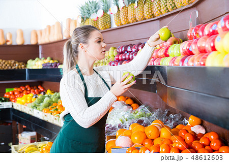 Young female in apron fresh apples and fruits Young female in apron fresh apples and fruits 48612603