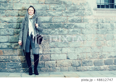 teenager girl in hood near wall 48612747